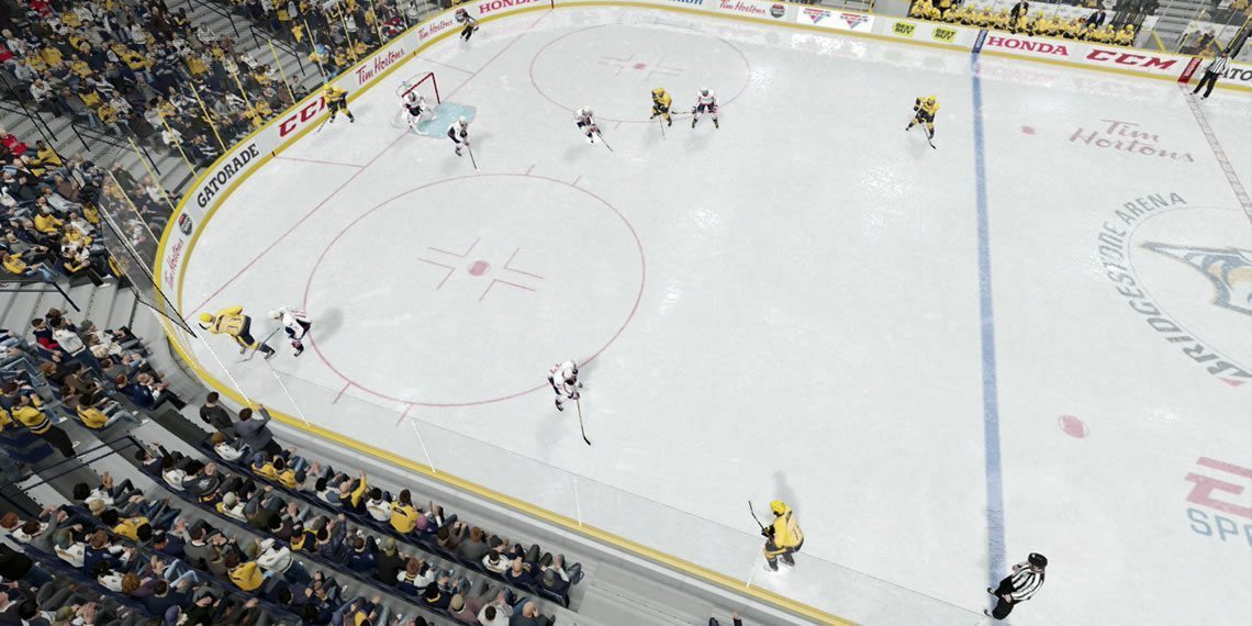 Players cycling the puck low along the boards behind the opposing teams net. 